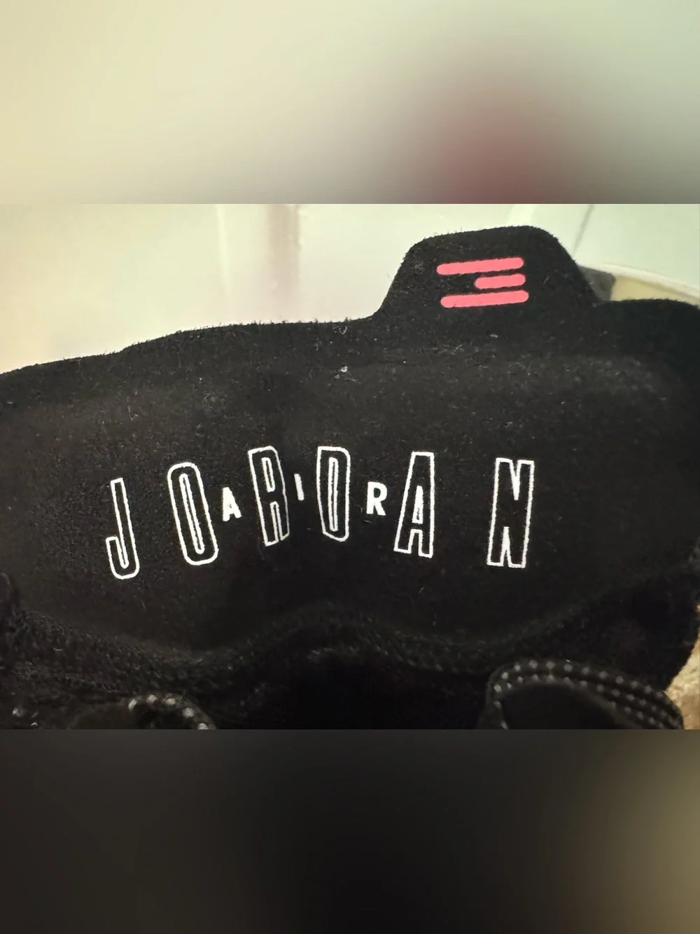 Boy’s Nike Air Jordan XXXVII Black Hot Punch basketball shoes.